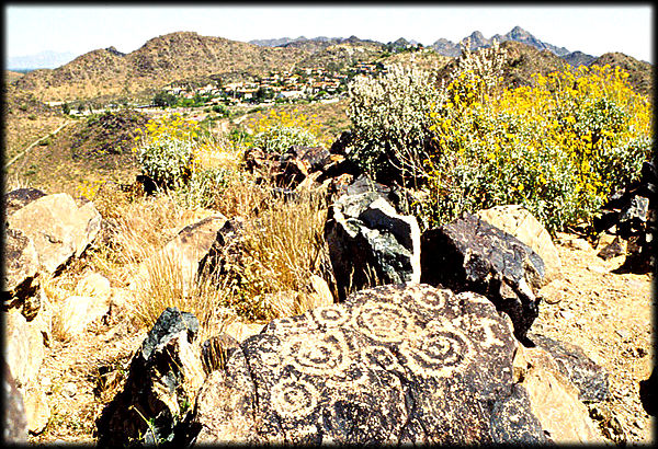 Ancient Hohokam spiral petroglyphs decorate a basalt boulder on Shaw Butte, in Phoenix, Arizona.