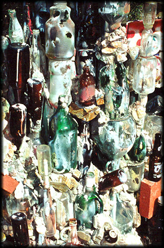A collage of glass bottles and ceramic vessels forms a wall at the Lee Oriental Rock Garden.