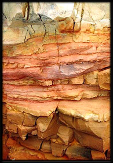 Bands of red and yellow iron oxides.
