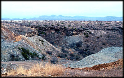 Green rocks and sand at the diggings on Peridot Mesa.
